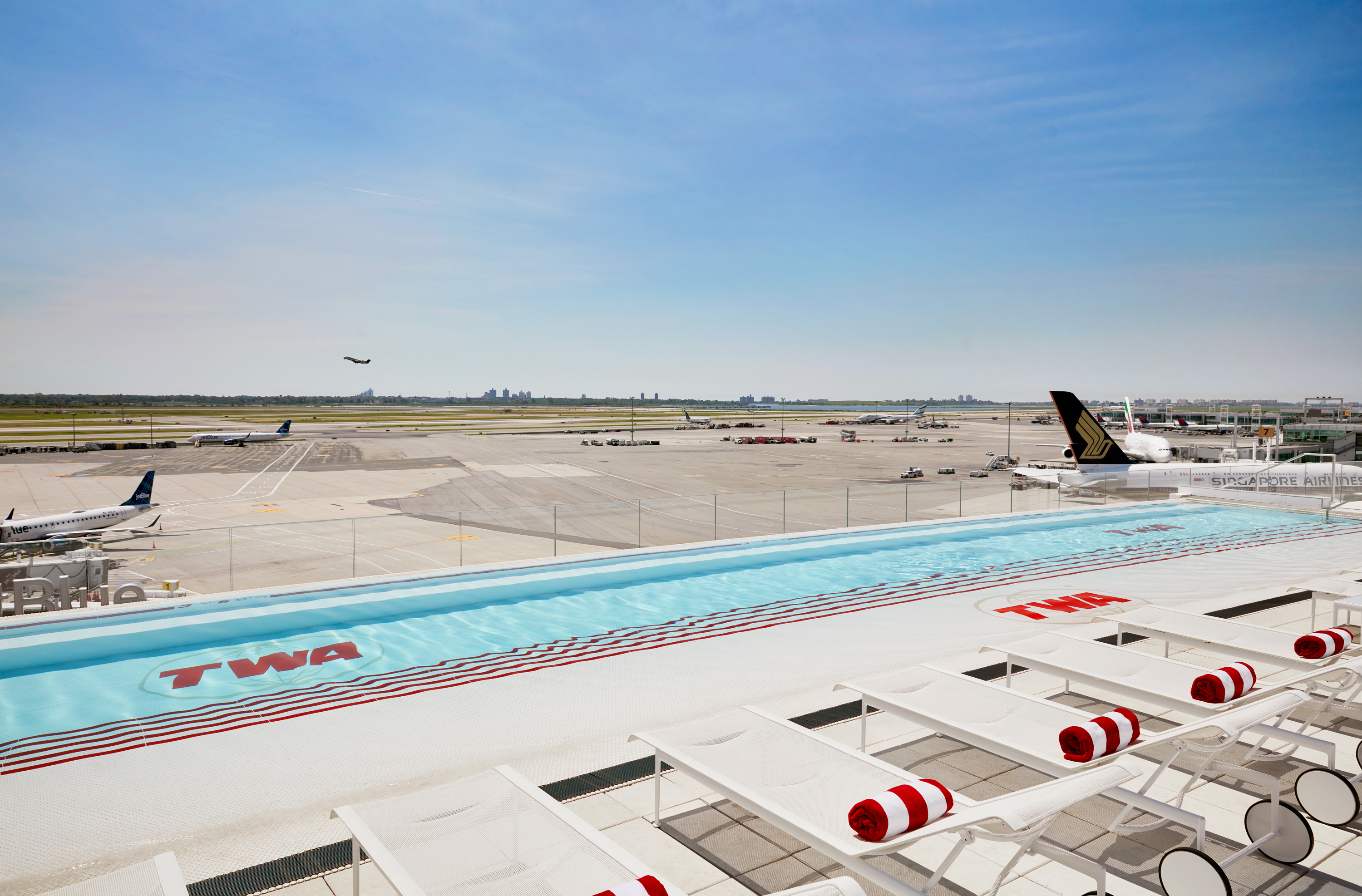 The pool is located on the TWA Hotel roof overlooking JFK’s runway 4L/22R.