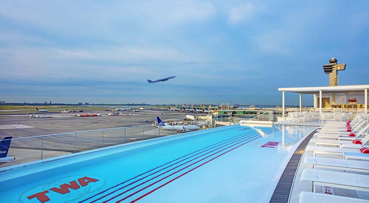 Plane flying over pool